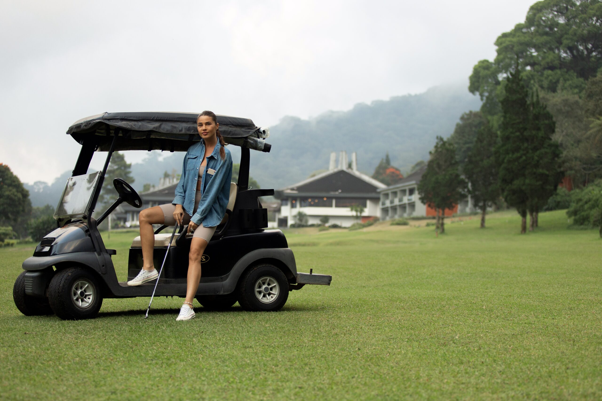 beautiful girl posing on the golf course. bali
